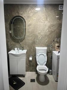 a bathroom with a toilet and a sink and a mirror at Apartman Latea in Banja Luka +13 photos