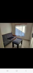 a room with a table and a bed and a window at La comarca Alquiler x día casa amplia con garagge in Patagones