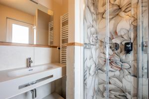 a bathroom with a shower and a sink at La Primula in Borgo San Dalmazzo