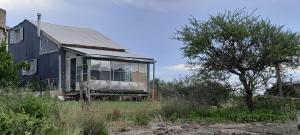 an old house sitting in the middle of a field at La Roca in Estancia Vieja +14 photos