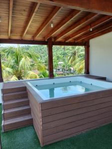 a hot tub in a patio with a roof at Vacacional las pascualas in Sánchez