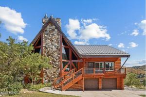a log cabin with a porch and a deck at Cozy Rustic Escape Near Park City Adventures in Park City