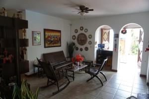 a living room with a table and chairs at Posada Cumpanama in Yurimaguas
