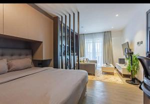 a bedroom with a large bed and a living room at Lifestyle Studio Apartment Escada 101 with Balcony in Nairobi +60 photos