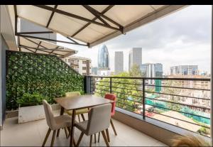 a balcony with a table and chairs and a view of the city at Lifestyle Studio Apartment Escada 101 with Balcony in Nairobi