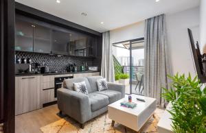 a living room with a couch and a table at Lifestyle Studio Apartment Escada 101 with Balcony in Nairobi