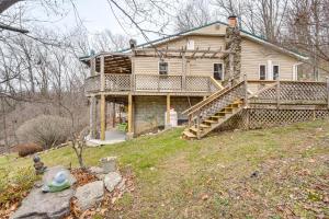 an old house with a porch and stairs on a hill at Knoxville Home On-Site Hiking and Outdoor Kitchen! in Knoxville