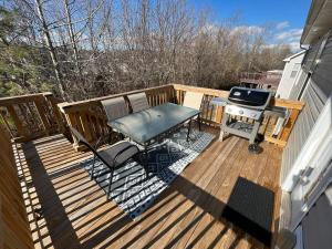 a deck with a picnic table and a grill at Spacious, 4BR Boho - Family & Pet Friendly in Clarksville