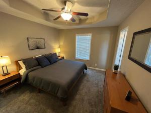 a bedroom with a bed and a ceiling fan at Spacious, 4BR Boho - Family & Pet Friendly in Clarksville