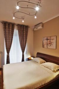 a bedroom with a large bed and a window at La Casa di Emma a Trastevere in Rome