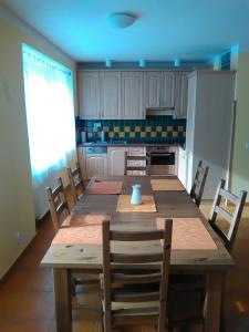 a kitchen with a large wooden table and chairs at Agroturistika kozí farma Rožnov pod Radhoštěm in Rožnov pod Radhoštěm