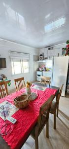 a kitchen with a table with a red table cloth at Casa Familiar en Playa Hermosa in Playa Hermosa