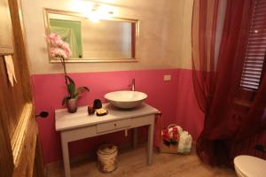 a bathroom with a sink and a mirror at Podere Osteria in Pienza +26 photos