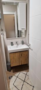 a bathroom with a sink and a mirror at Apartman Mali princ Jahorina in Jahorina +5 photos