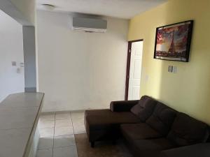 a living room with a couch and a wall at Hotel Albatros Palace - Bungalow G in Manzanillo