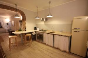 a kitchen with a refrigerator and a counter top at Podere Osteria in Pienza