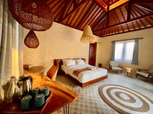 a bedroom with a bed and a table in a room at Sanur ocean view villas in Sanur +58 photos