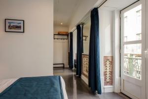 a bedroom with a bed and a window at PH Downtown Suites in Lisbon