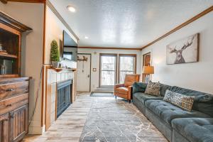 a living room with a couch and a fireplace at Brian Head Condo with Pool Access - Steps to Resort! in Brian Head