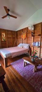 a bedroom with a bed and a ceiling fan at The Lighthouse Retreat, Little Corn island, Nicaragua in Little Corn Island
