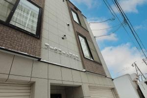 a building with windows on the side of it at SapporoCity Ark Coat 302 LuxuryRoom in Minami-jūichijō