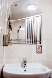 a bathroom with a sink and a mirror at Mini-Hotel Ilma in Petrozavodsk