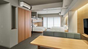 a hotel room with two beds and a couch at MIMARU Kyoto Kawaramachi Gojo in Kyoto +39 photos
