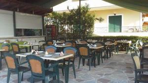 a row of tables and chairs at a restaurant at Gefyra Rooms in Ancient Epidauros +67 photos