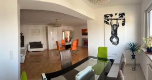 a dining room and living room with a table and chairs at VIENNA & ENJOY `s in Leopoldsdorf
