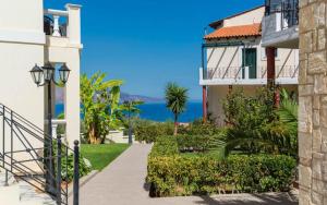a walkway between two buildings with a view of the ocean at Antilia Apartments in Tavronitis