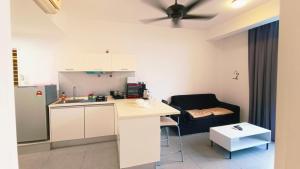 a small kitchen with a table and a chair at Empire home in Cyberjaya
