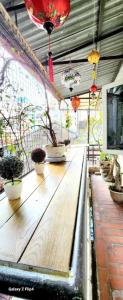 a long wooden table with potted plants on it at Nhà riêng 3 phòng ngủ 6 giường in Hanoi