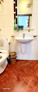 a bathroom with a sink and a toilet and a mirror at Nhà riêng 3 phòng ngủ 6 giường in Hanoi +17 photos