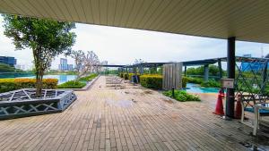 a walkway with benches and trees in a building at Empire home in Cyberjaya