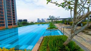 a large swimming pool in a building with a tree at Empire home in Cyberjaya
