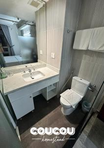 a bathroom with a toilet and a sink and a mirror at CouCou Homestead II - Mini Hotel District 1 in Ho Chi Minh City +118 photos