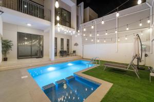 a swimming pool in a building with a playground at Amazing Private Pool 4 Bedroom House - Damac Hills 2 Dubai Land in Dubai