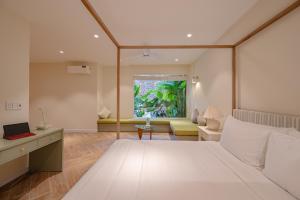 a bedroom with a large bed and a living room at Sip Boutique Villa & Apartment in Hoi An +53 photos