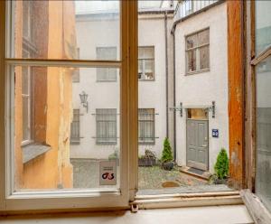 an open window with a view of a street at Vecrīgas dzīvoklis in Riga +12 photos