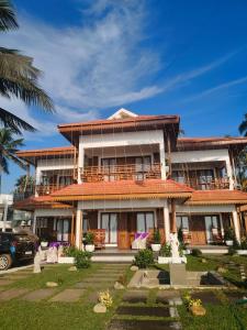 a large building with a yard in front of it at Flower Hill Cottage in Varkala