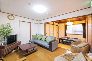 a living room with a couch and a tv at 二条駅から徒歩10分 in Kyoto