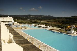 a large swimming pool with chairs and a resort at Sintra Sol - Apartamentos Turisticos in Sintra