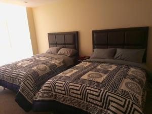 two beds sitting next to each other in a bedroom at Apartment in La Paz #07 in La Paz