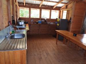 a kitchen with a sink and a refrigerator in a cabin at Cabaña Paraíso Verde in Providencia