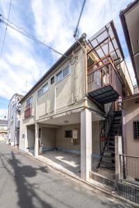 a building with a staircase on the side of it at 二条駅から徒歩10分 in Kyoto