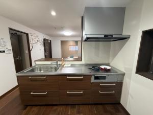 a kitchen with a sink and a stove at 風花Fuka民泊大森西002 in Tokyo +24 photos
