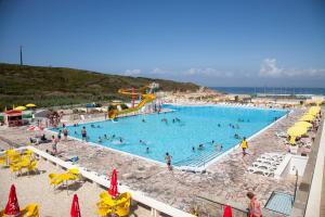 a large swimming pool with people at a resort at Sintra Sol - Apartamentos Turisticos in Sintra