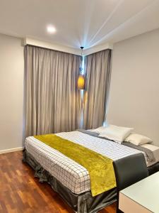 a bedroom with a large bed in front of a window at LUXURY 3r2b Penthouse The Shore Hotel & Residences in Melaka