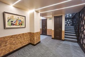 a hallway with stairs and a painting on the wall at Qo'noq Tashkent Airport Hotel Sleep Lounge & Showers, Terminal 2 - TRANSIT ONLY in Tashkent