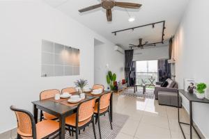 a dining room and living room with a table and chairs at Razak City Residence by Lisa Homestay in Kuala Lumpur